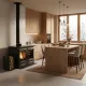 Cuisinière à bois Alaska noire installée dans une cuisine moderne avec conduit d'évacuation et rangement bûches