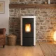 Poêle à granulés Moira EVO 7 kW noir et blanc en situation dans un salon avec mur en pierre